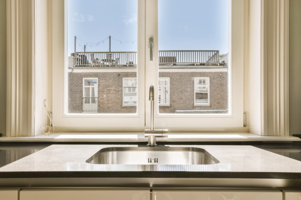 a kitchen sink in front of a window